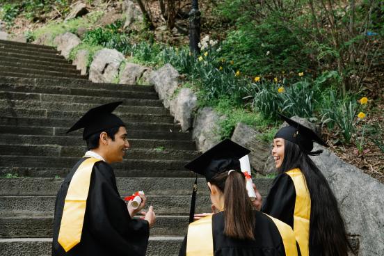 Three students in graduation regalia