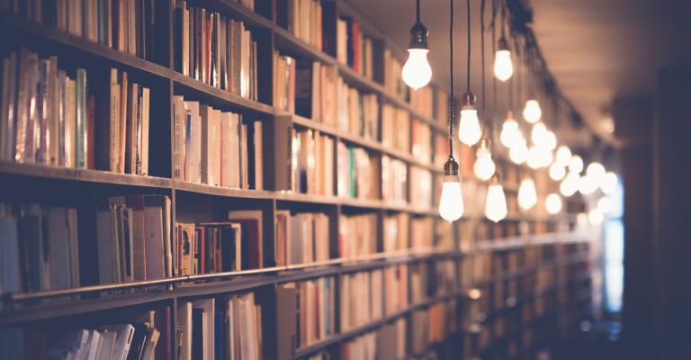 Dimly lit row of bookshelves