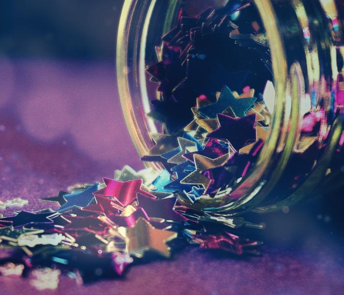 Star confetti spilling from a jar